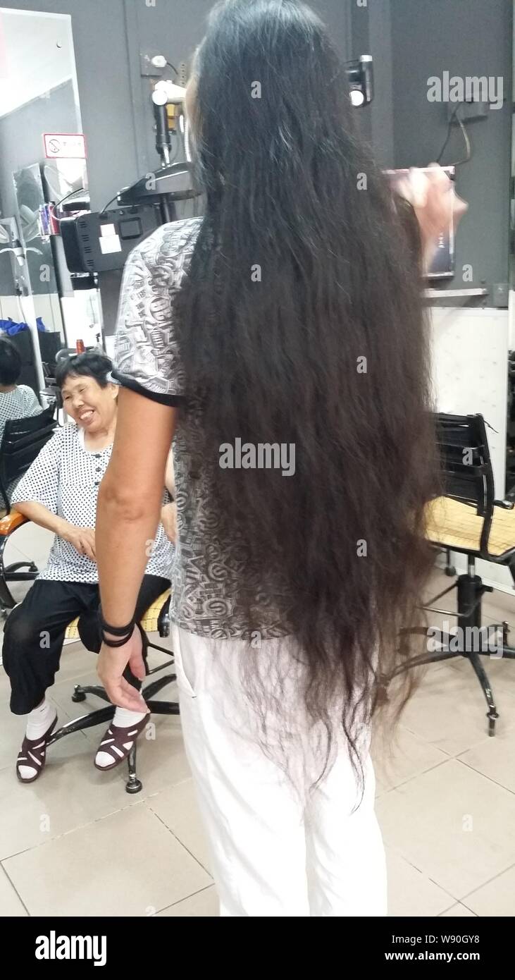 Chinese Hairdresser Yan Xiaoping Poses To Show His Long Hair At A Hair Salon In Shenzhen City South China S Guangdong Province 10 September 2014 Stock Photo Alamy