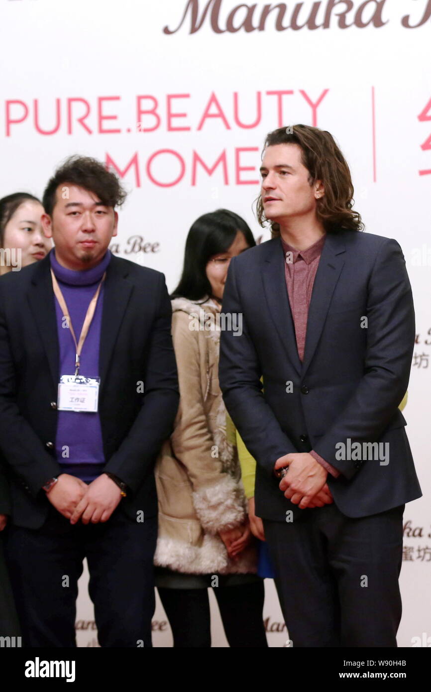 English actor Orlando Bloom, right, attends a promotional event for Manuka Bee Lip Care in Shanghai, China, 16 December 2014. Stock Photo
