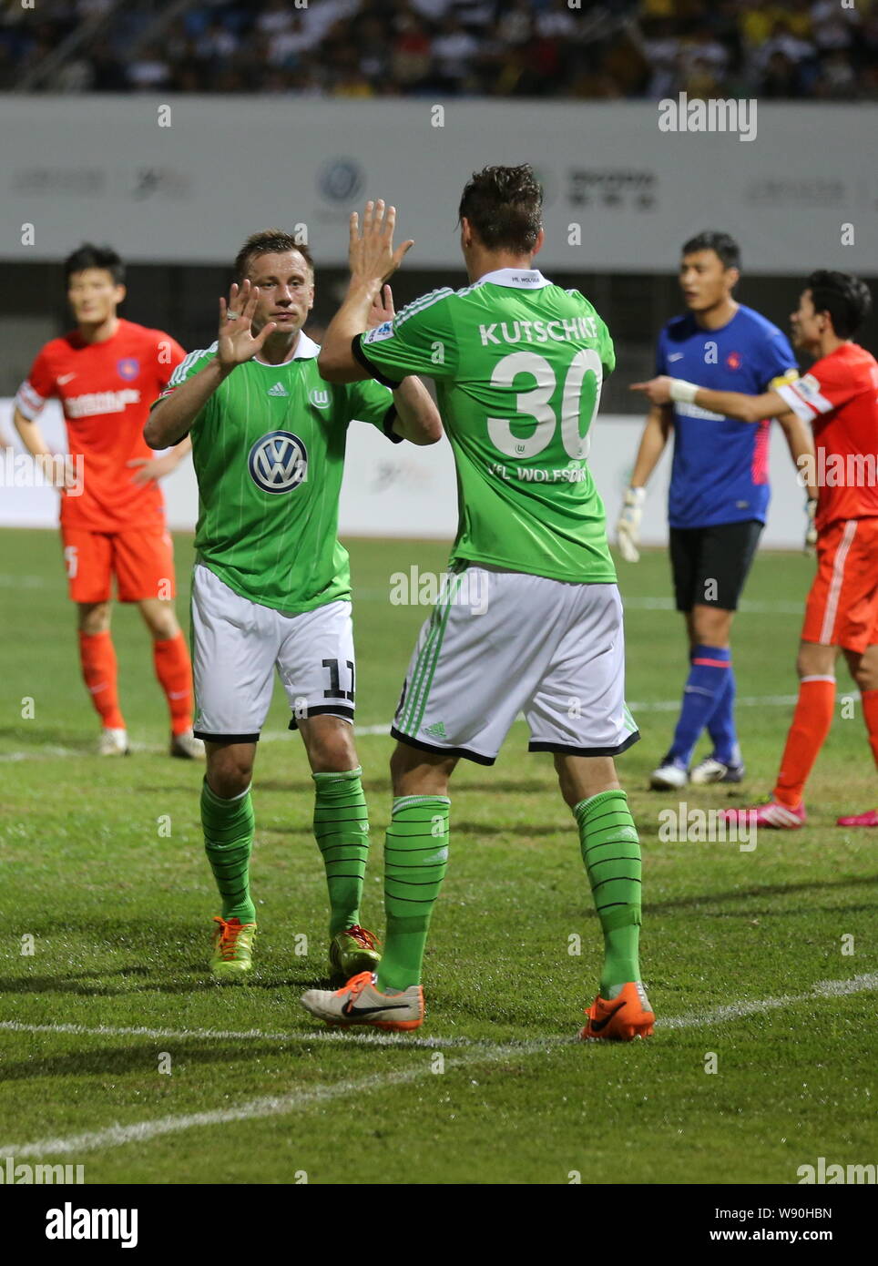 Ivica Olic, front left, and Stefan Kutschke of Germanys VfL Wolfsburg celebrate after scoring a goal against Chinas Qingdao Jonoon in a soccer friendl Stock Photo