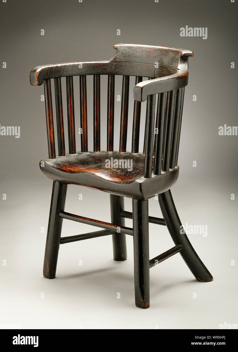 Old wooden childs' seat. Stock Photo