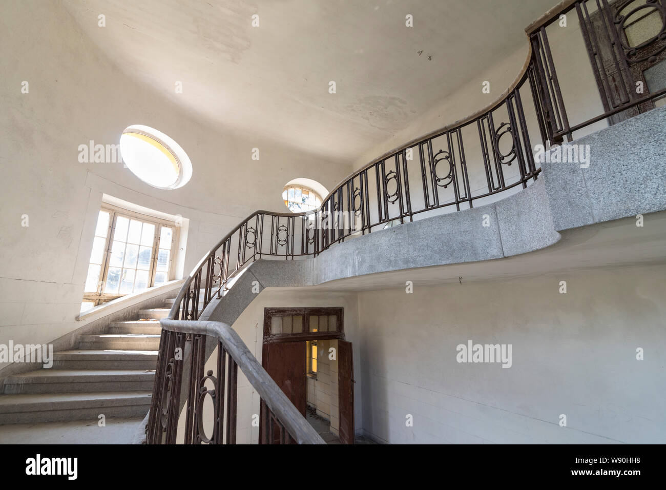 Stairway at interior of former historical barracks, officers building 'Haus der Offiziere', abandoned by the Russian army in 1994 Stock Photo