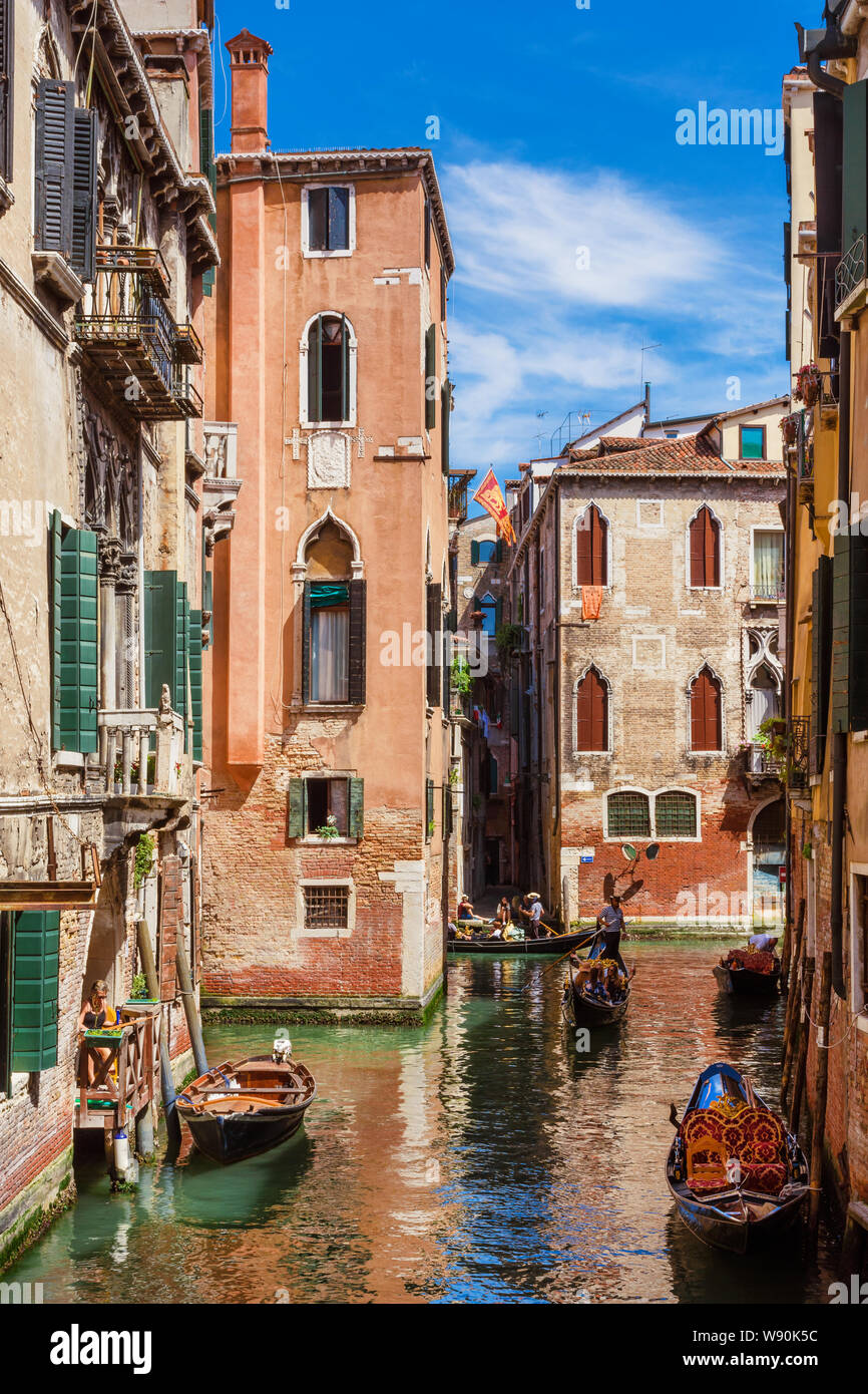 Tourism in Venice. Gondolas in the city inner canals Stock Photo