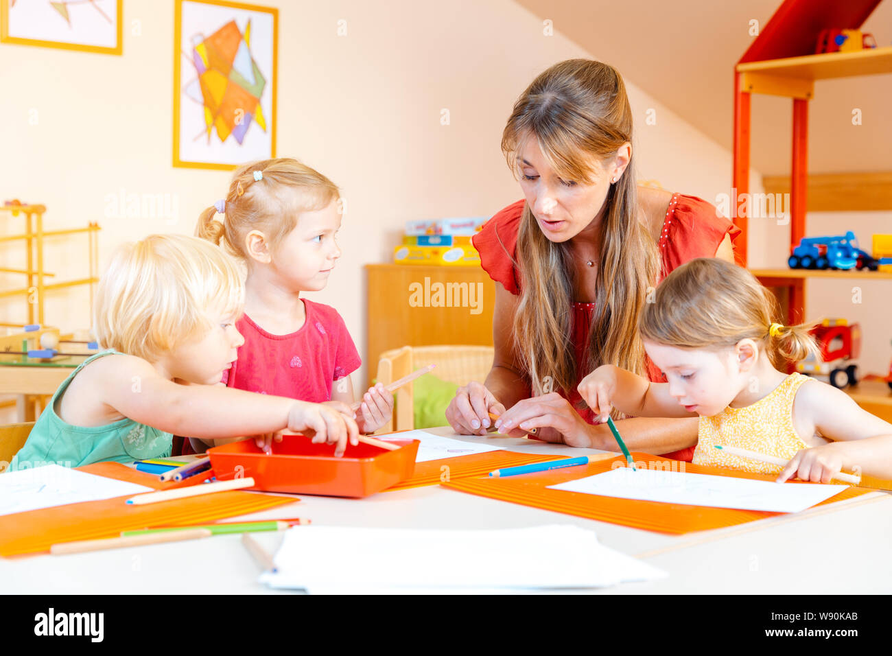 Children drawing in playgroup of nursery school Stock Photo