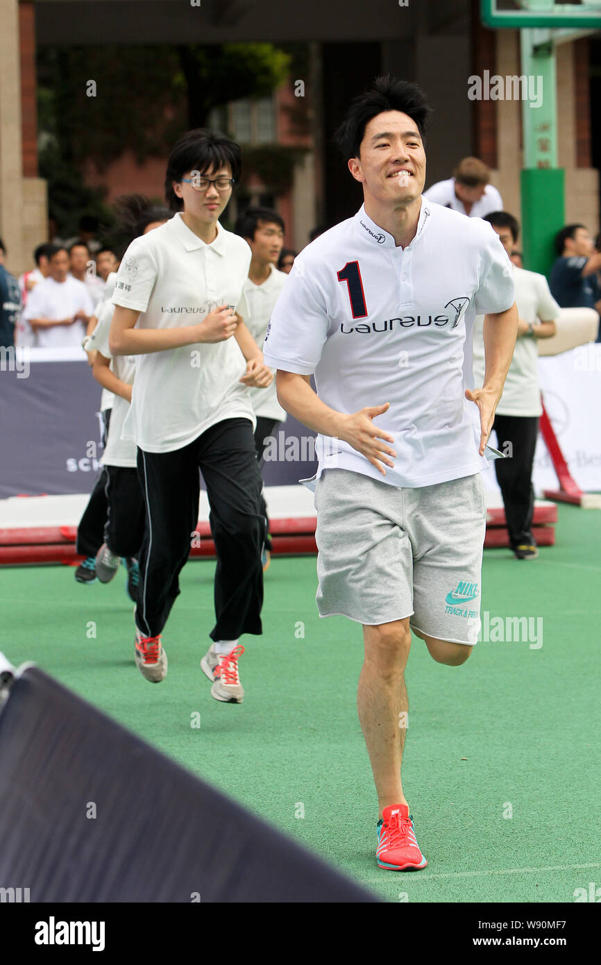 Chinese star hurdler Liu Xiang, front, runs with Chinese students