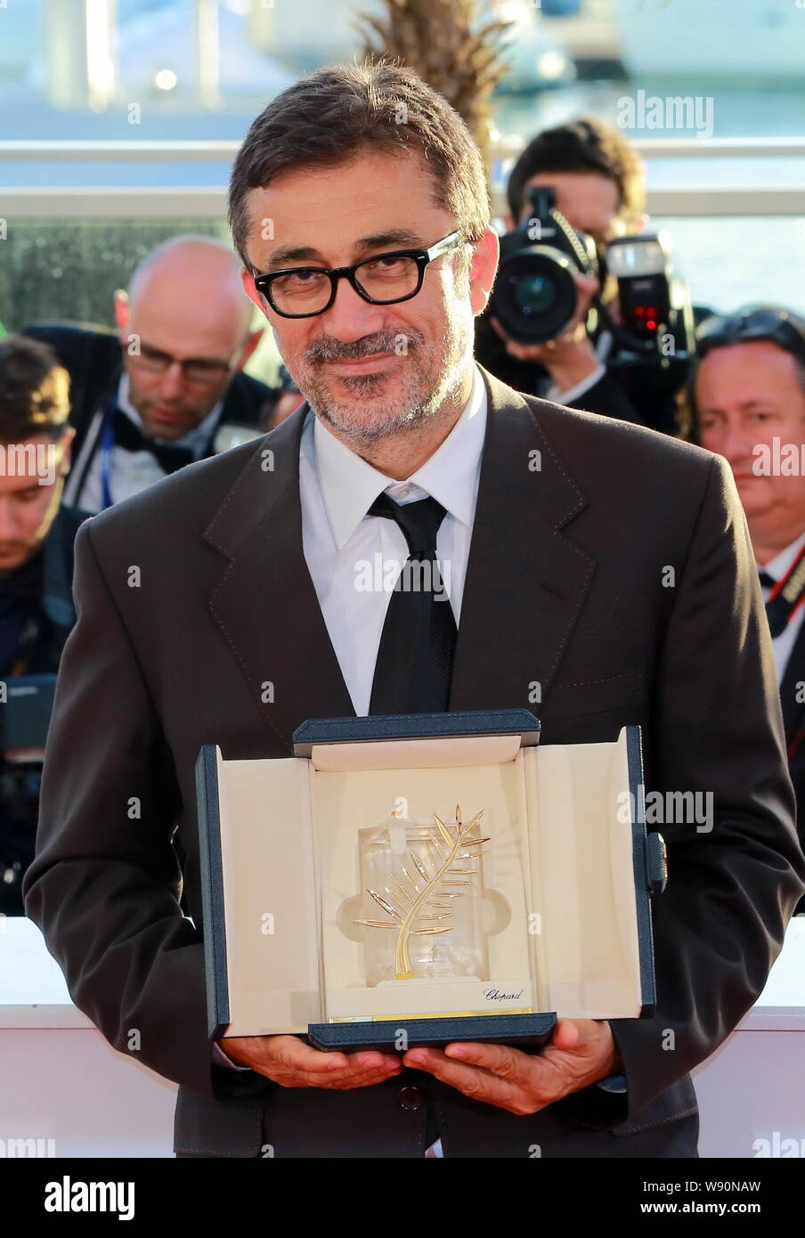 Turkish actor and director Nuri Bilge Ceylan poses with his Palme dOr award after winning the Best Film Award for his movie, Winter Sleep, at the phot Stock Photo
