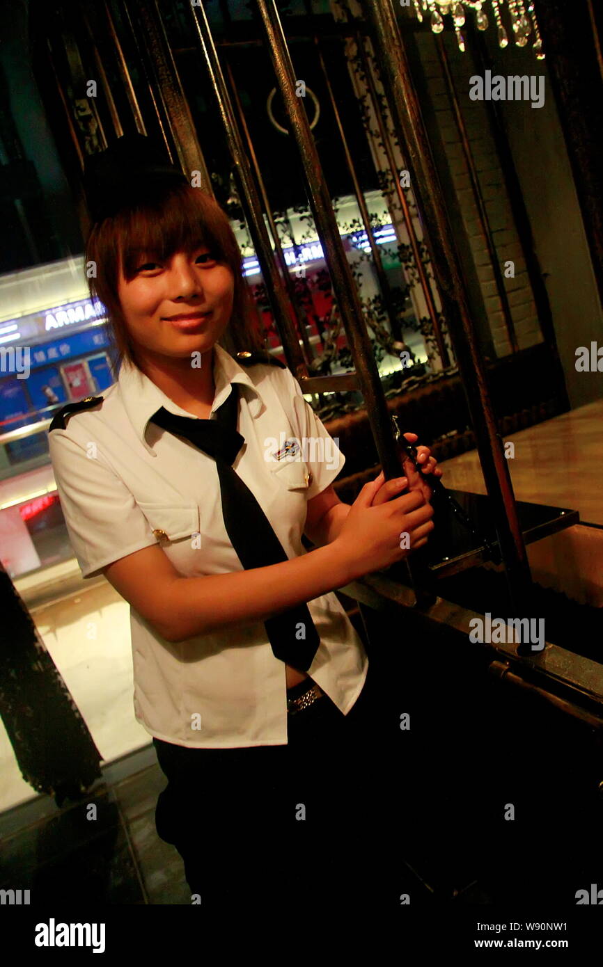 A waitress stands outside in an eating room at the first prison-themed restaurant in Tianjin, China, 6 September 2014.   A special restaurant modeled Stock Photo