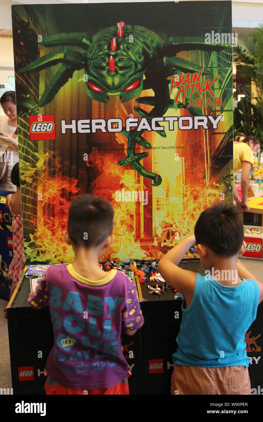 --FILE--Two boys play with Lego toys at Wuhan International Plaza in Wuhan, central Chinas Hubei province, 28 July 2013.      Construction of L egos f Stock Photo
