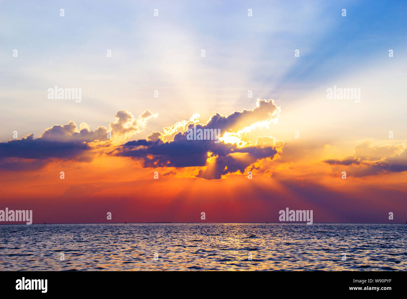 Beautiful sunset above the sea reflected on surface water colorful ...