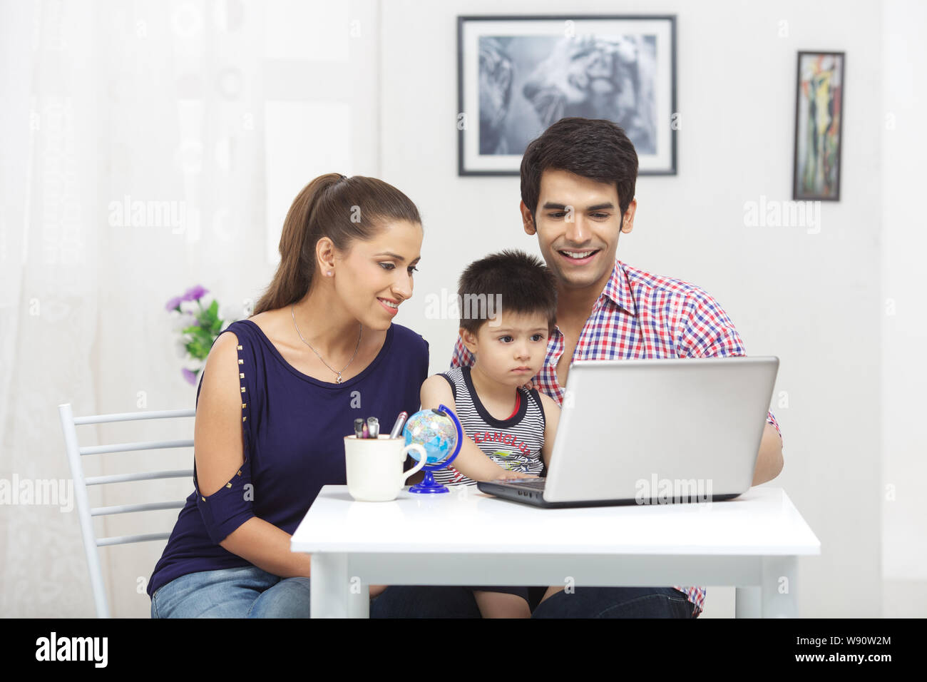 Family using laptop Stock Photo - Alamy