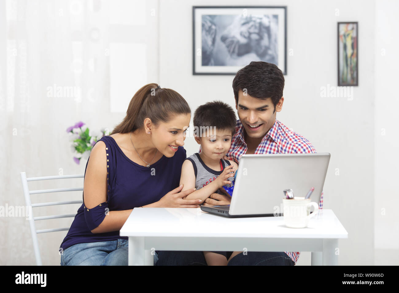 Family using laptop Stock Photo - Alamy