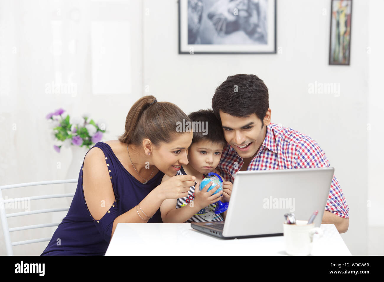 Family using laptop Stock Photo - Alamy