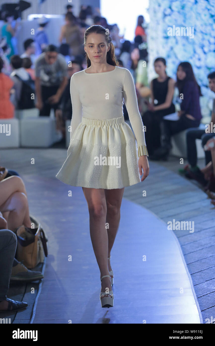 A model displays a new creation at the Alan & Cross fashion show during