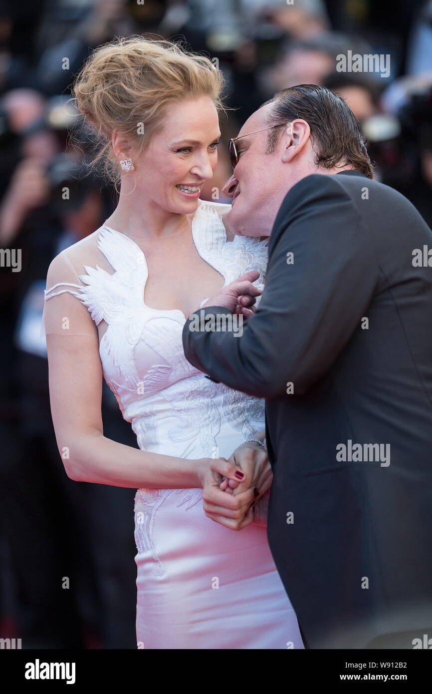 American director Quentin Tarantino, right, whispers to actress Uma Thurman as they arrive at the red carpet for the closing ceremony of the 67th Cann Stock Photo