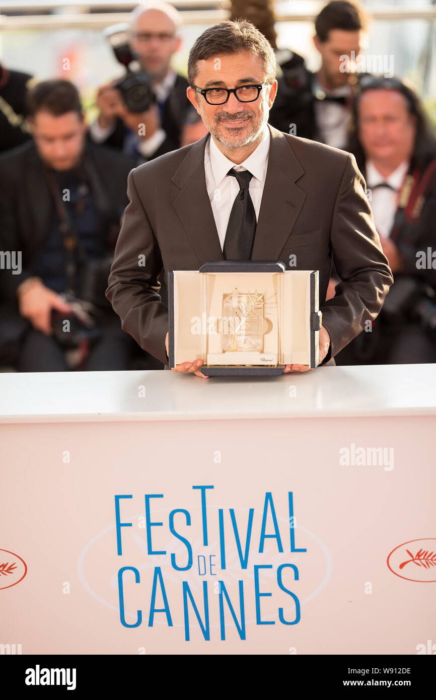 Turkish actor and director Nuri Bilge Ceylan poses with his Palme dOr award after winning the Best Film Award for his movie, Winter Sleep, at the phot Stock Photo