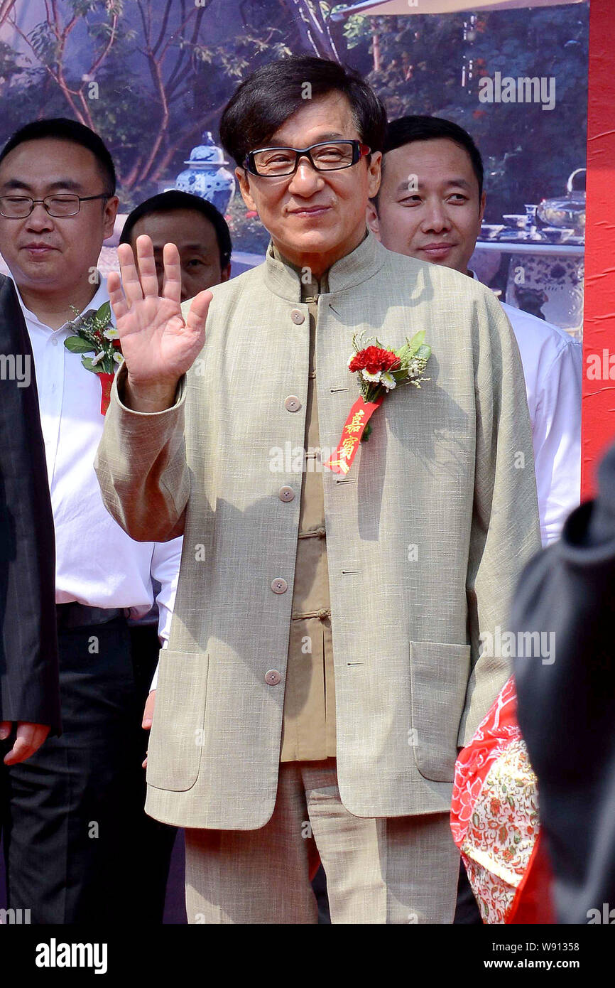 Hong Kong actor Jackie Chan waves during a press conference for Chinese architectural culture in Beijing, China, 27 April 2014. Stock Photo