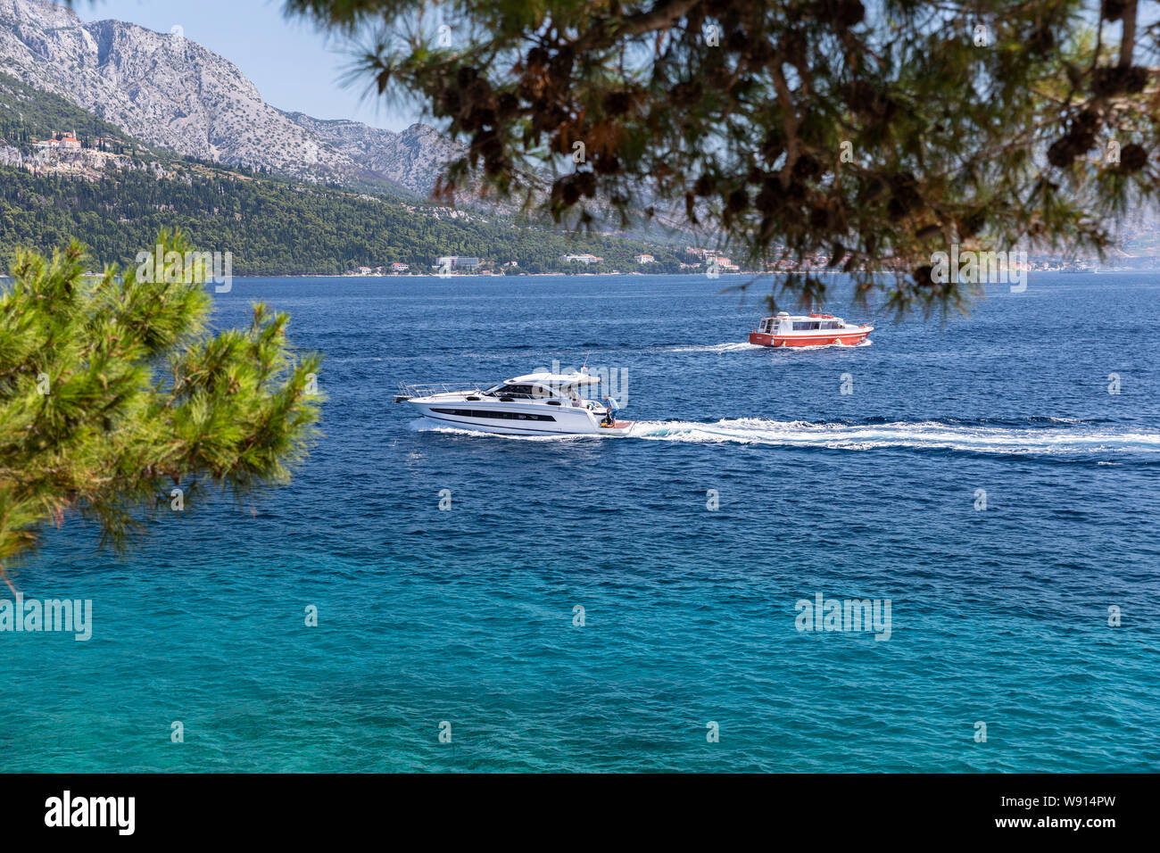 Boats sails near Korcula old town, peninsula Peljecac in the background Stock Photo