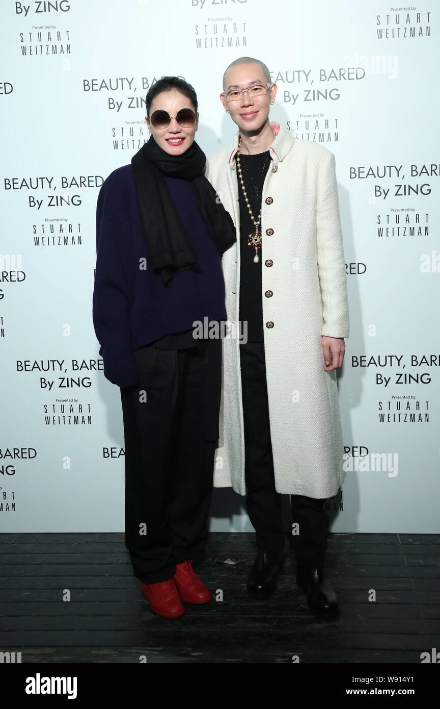 Hong Kong singer Faye Wong, left, and her image designer Zing pose during the Beauty & Bared exhibition in Beijing, China, 26 November 2014. Stock Photo