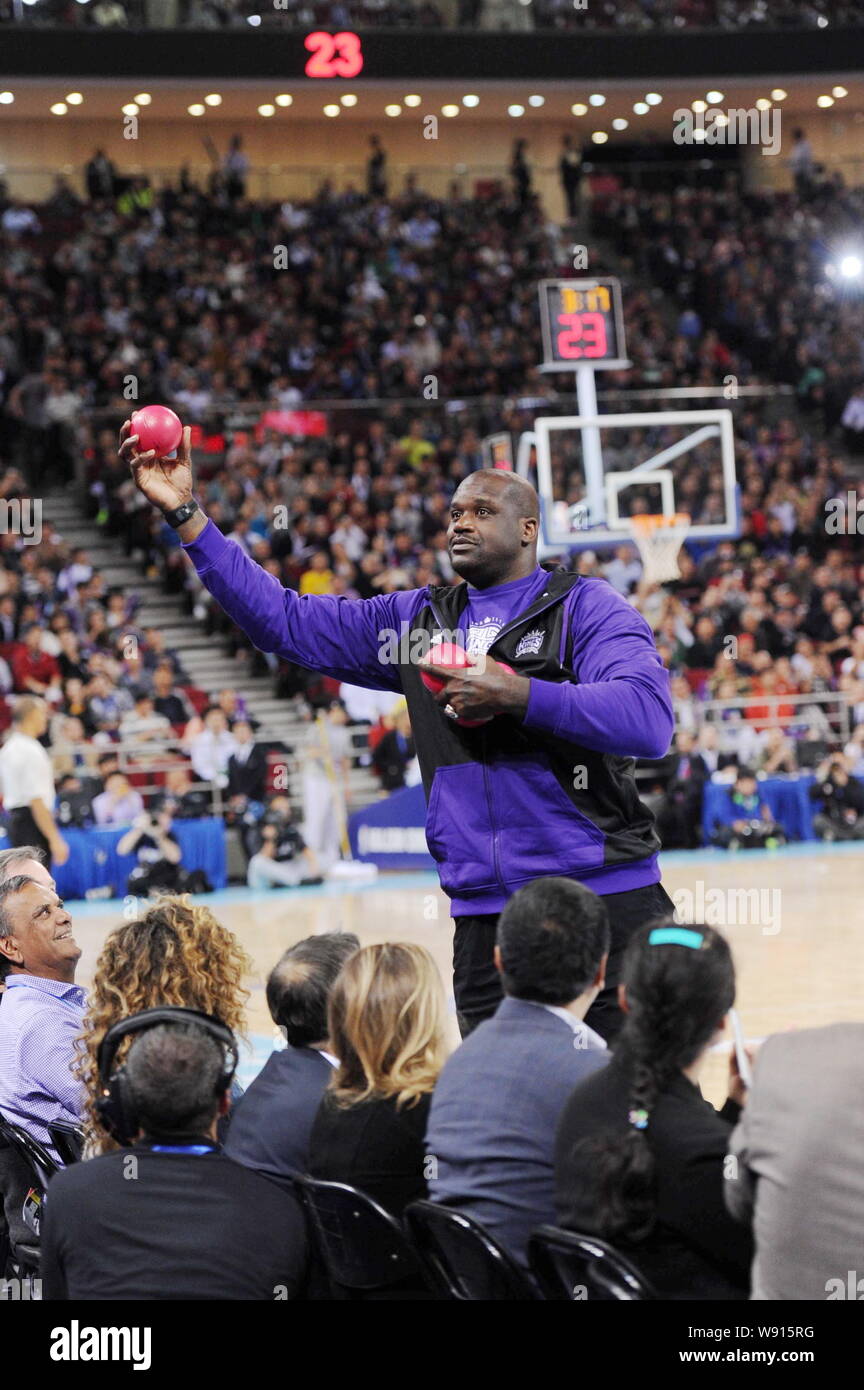 Retired NBA star Shaquille O'Neal prepares to throw balls to spectators as gifts before an NBA exhibition game between Sacramento Kings and Brooklyn N Stock Photo