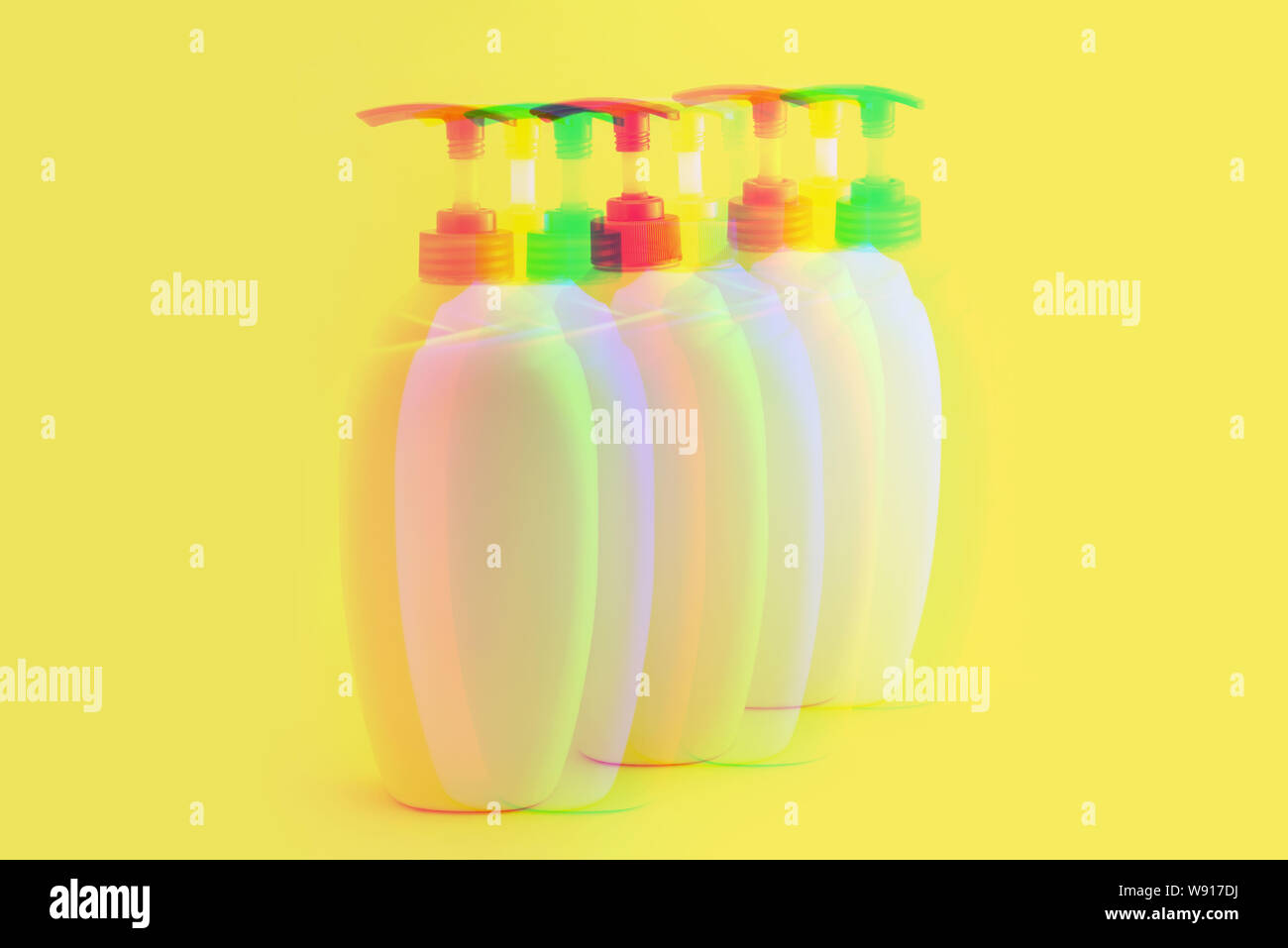 Glitch effect. Packaging bottles for cosmetics on a yellow background Stock Photo