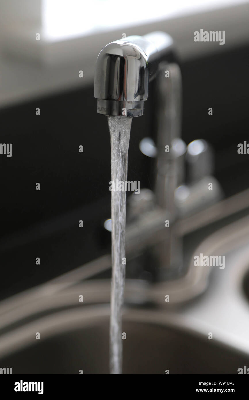 Running kitchen water tap Stock Photo Alamy