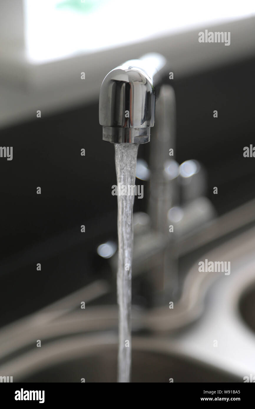Running kitchen water tap Stock Photo Alamy