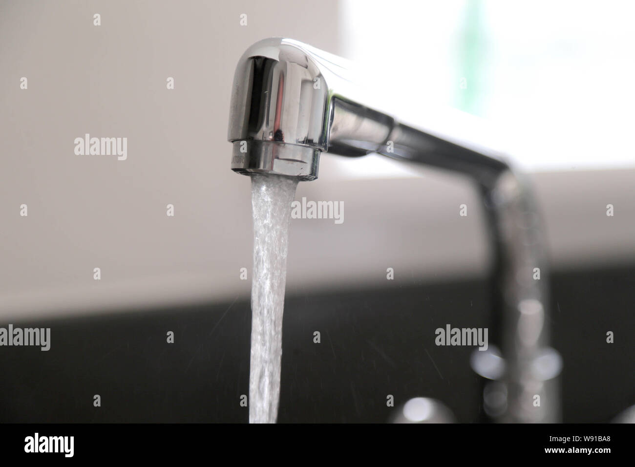 Running kitchen water tap Stock Photo Alamy