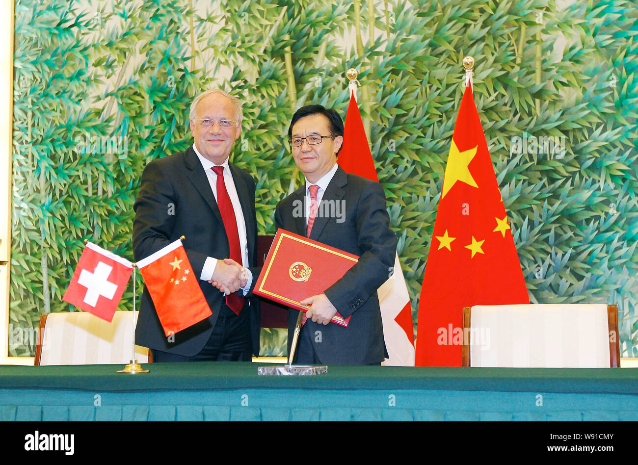 Chinese Commerce Minister Gao Hucheng, right, and Swiss Federal Counsellor Johann Schneider-Ammann, left, pose for photos after they signed a free-tra Stock Photo
