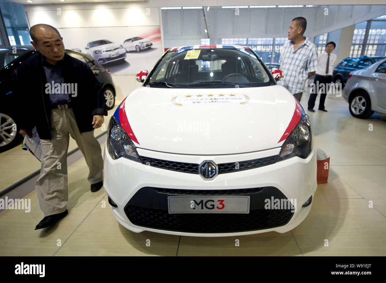 --FILE--Visitors look at an MG 3 of SAIC Motor during an auto show in Beijing, China, 13 September 2012.   SAIC Motor Corp., Chinas largest automaker, Stock Photo