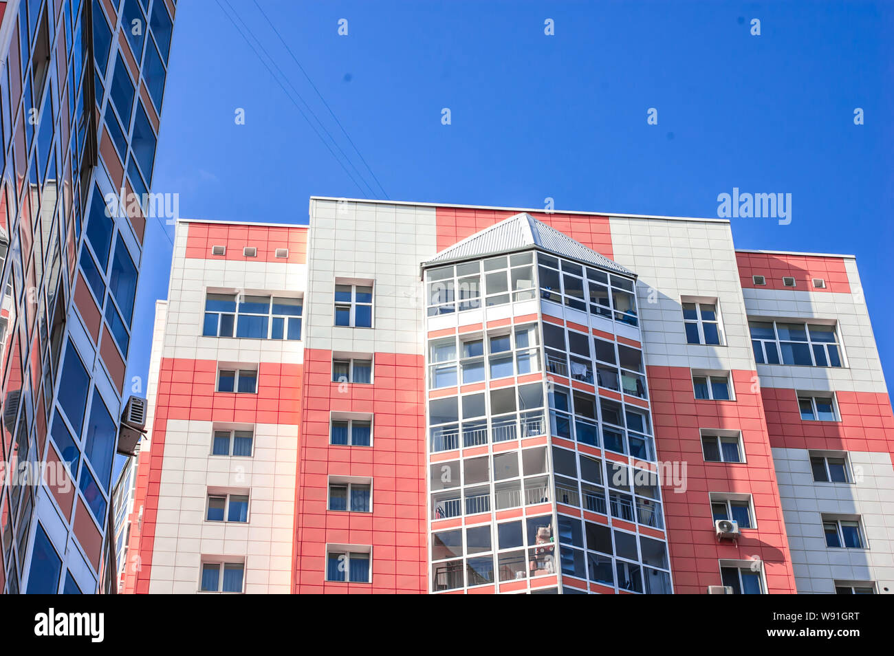 Multi-storey residential building on the blue sky and clouds Stock ...