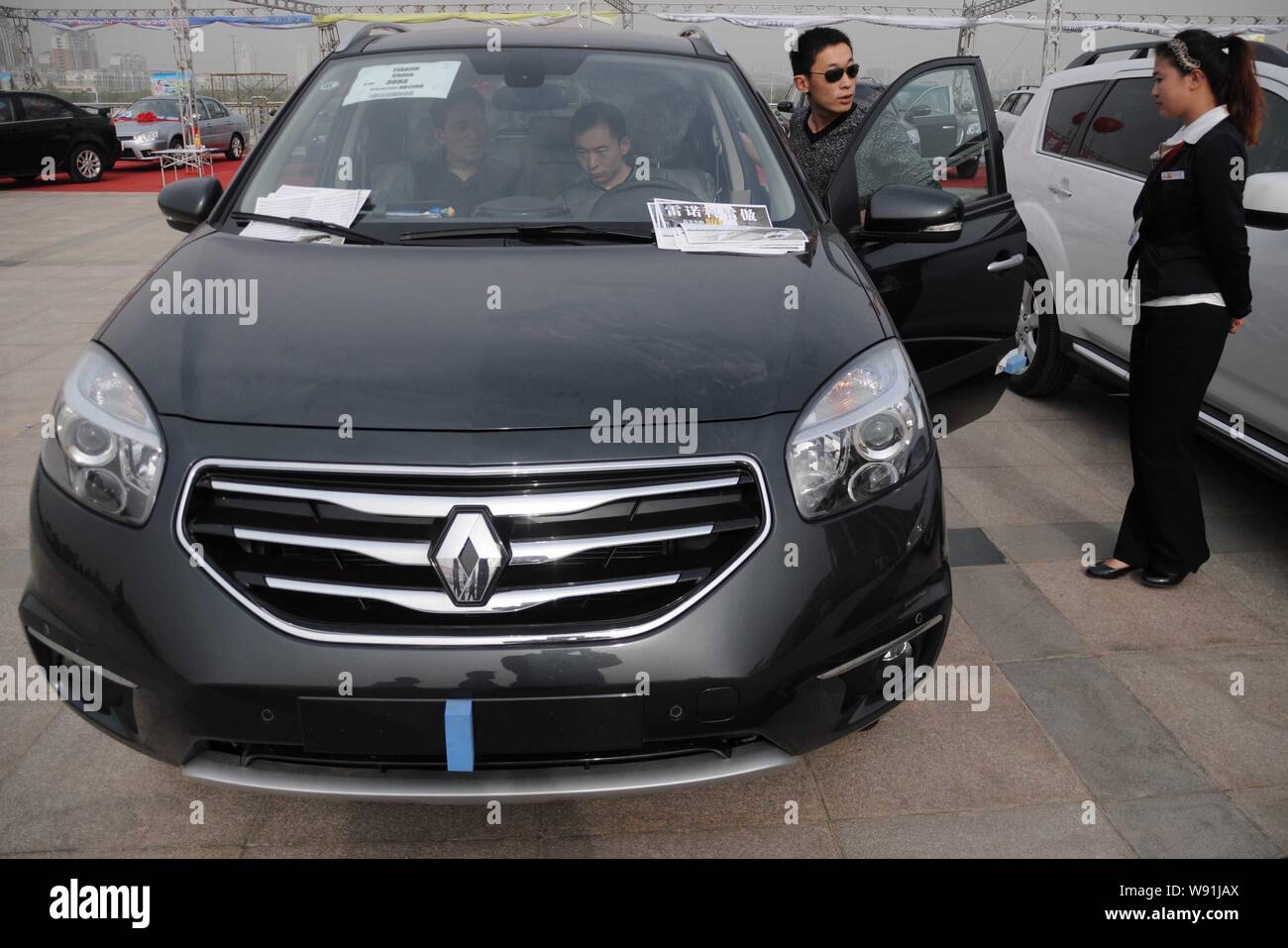 --FILE--Visitors try out a Renault Koleos during an auto show in Binzhou city, east Chinas Shandong province, 28 April 2012.   French auto maker Renau Stock Photo