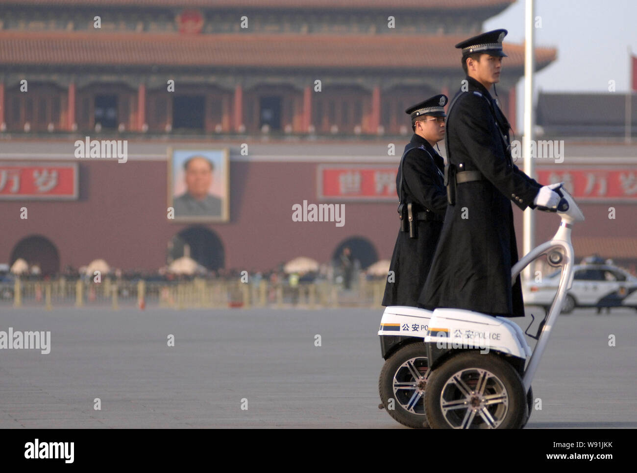 Chinese police officers drive Segway-like two-wheeled electric vehicle to patrol Tiananmen Square during the First Session of the 12th National Commit Stock Photo