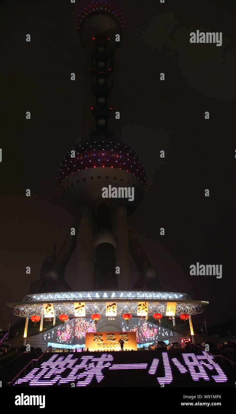Night view of the Oriental Pearl TV Tower after most of the lights were turned off during Earth Hour in the Lujiazui Financial District in Pudong, Sha Stock Photo