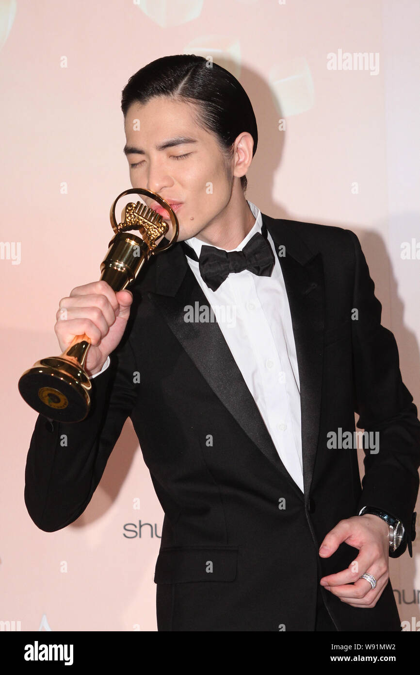 Taiwanese singer Jam Hsiao kisses his trophy after the award ceremony of the 24th Taiwan Golden