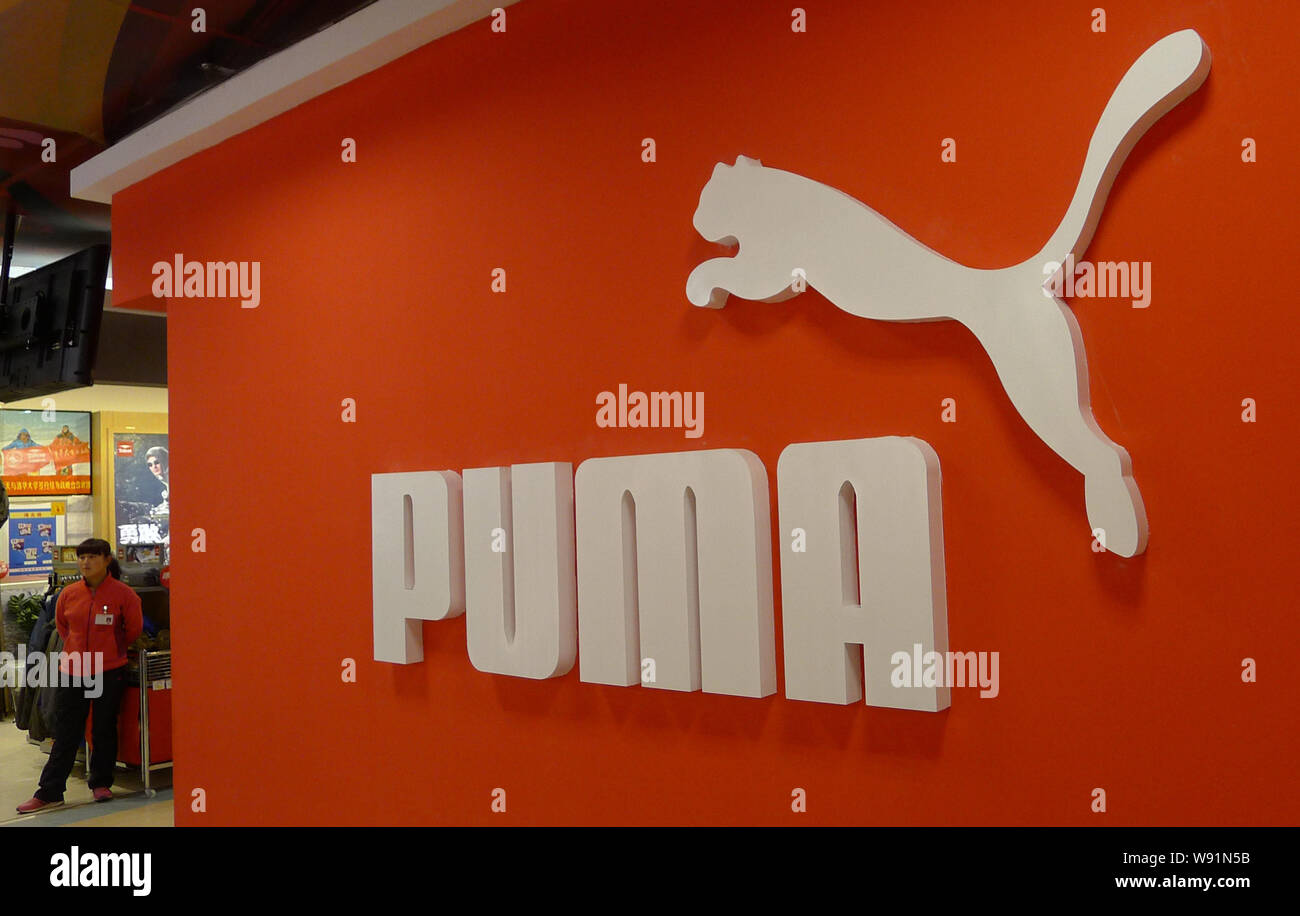 FILE--An employee is seen at a store of German sportswear brand Puma in  Qingdao, east Chinas Shandong province, 18 January 2013. A growing number  Stock Photo - Alamy