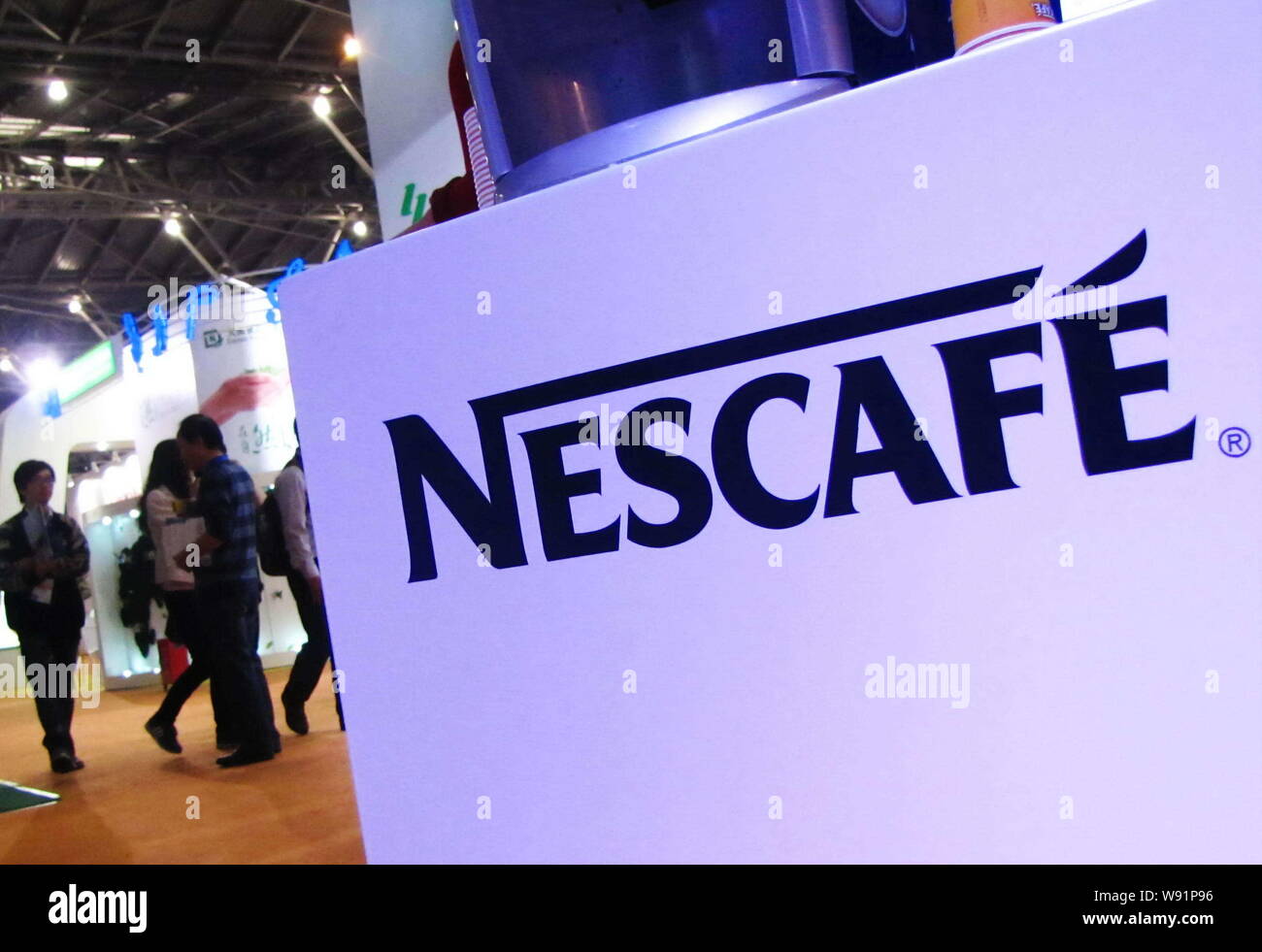 --FILE--Visitors walk past the stand of Nescafe of Nestle during an expo in Shanghai, China, 6 November 2011.   Nestle SA, the worlds biggest food mak Stock Photo