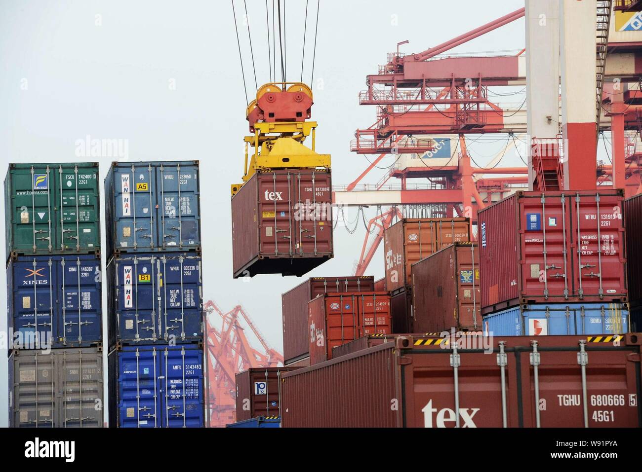 --FILE--Containers are lifted at the port in Qingdao, east Chinas Shandong province, 12 November 2012.   Chinese exports and imports rebounded strongl Stock Photo