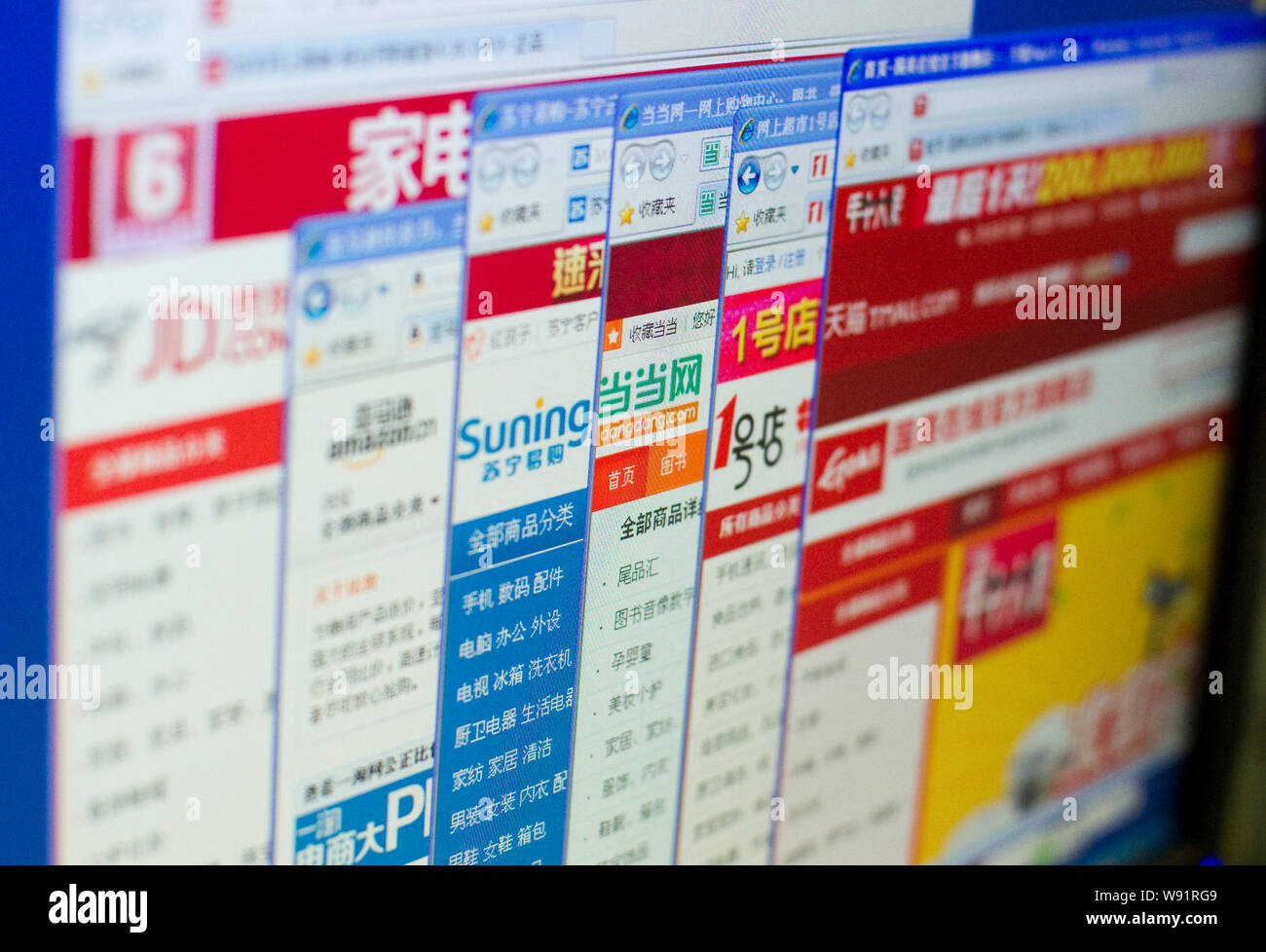 --FILE--A netizen browses the Chinese websites of (from left) JD.com, amazon.cn, Suning.com, dangdang.com, yihaodian.com and tmall.com of Alibaba Grou Stock Photo
