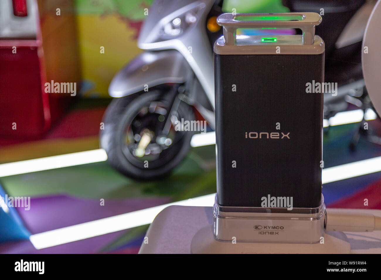Taichung, Taiwan - August 4, 2019: Kymco IoneX battery-powered electric scooter display with batteries and charging stations. Alternative energy conce Stock Photo