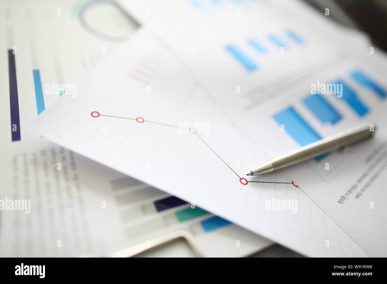 Silver pen lies on documents with Stock Photo