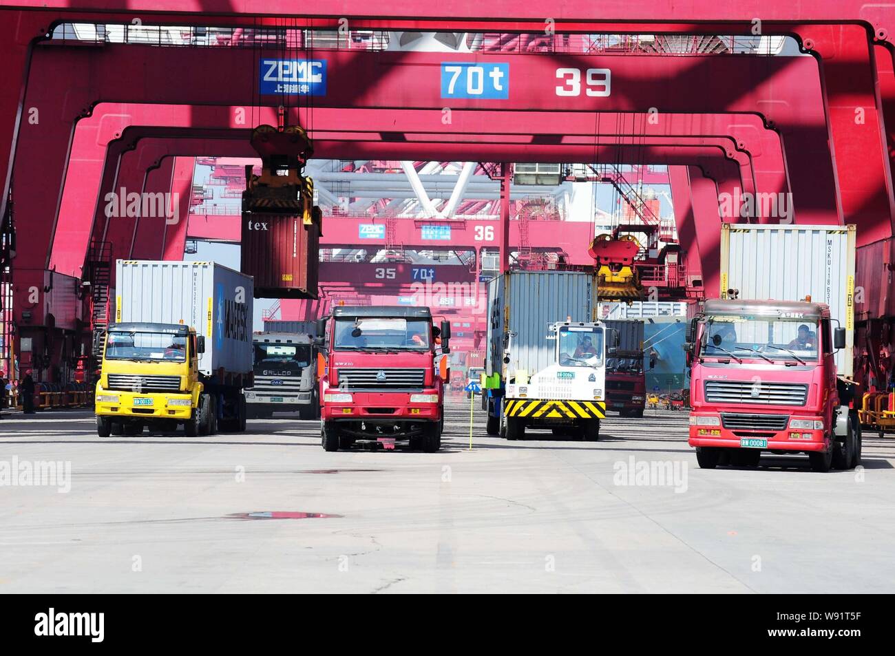 --FILE--Container trucks are loaded at a port in Qingdao, east Chinas Shandong province, 30 April 2012.   Chinese exports and imports rebounded strong Stock Photo