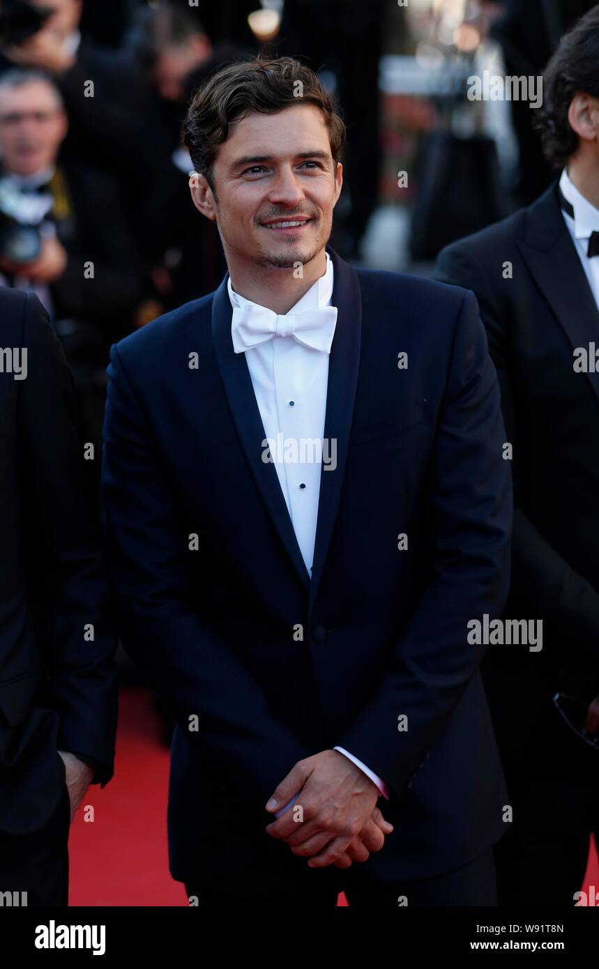 English actor Orlando Bloom poses on the red carpet as he arrives for