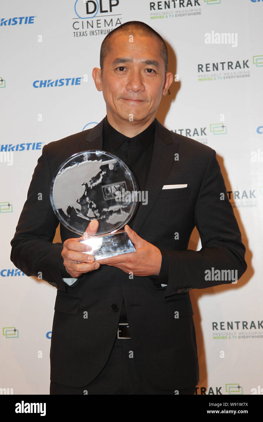 Hong Kong singer and actor Tony Leung Chiu-Wai poses with his trophy for the honor as Actor Extraordinaire for 2013 at the CineAsia 2013 in Hong Kong, Stock Photo