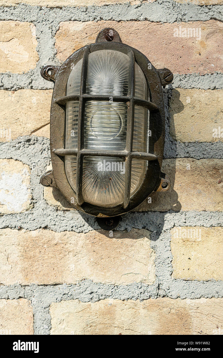 the old lamp hanging on the brick wall Stock Photo