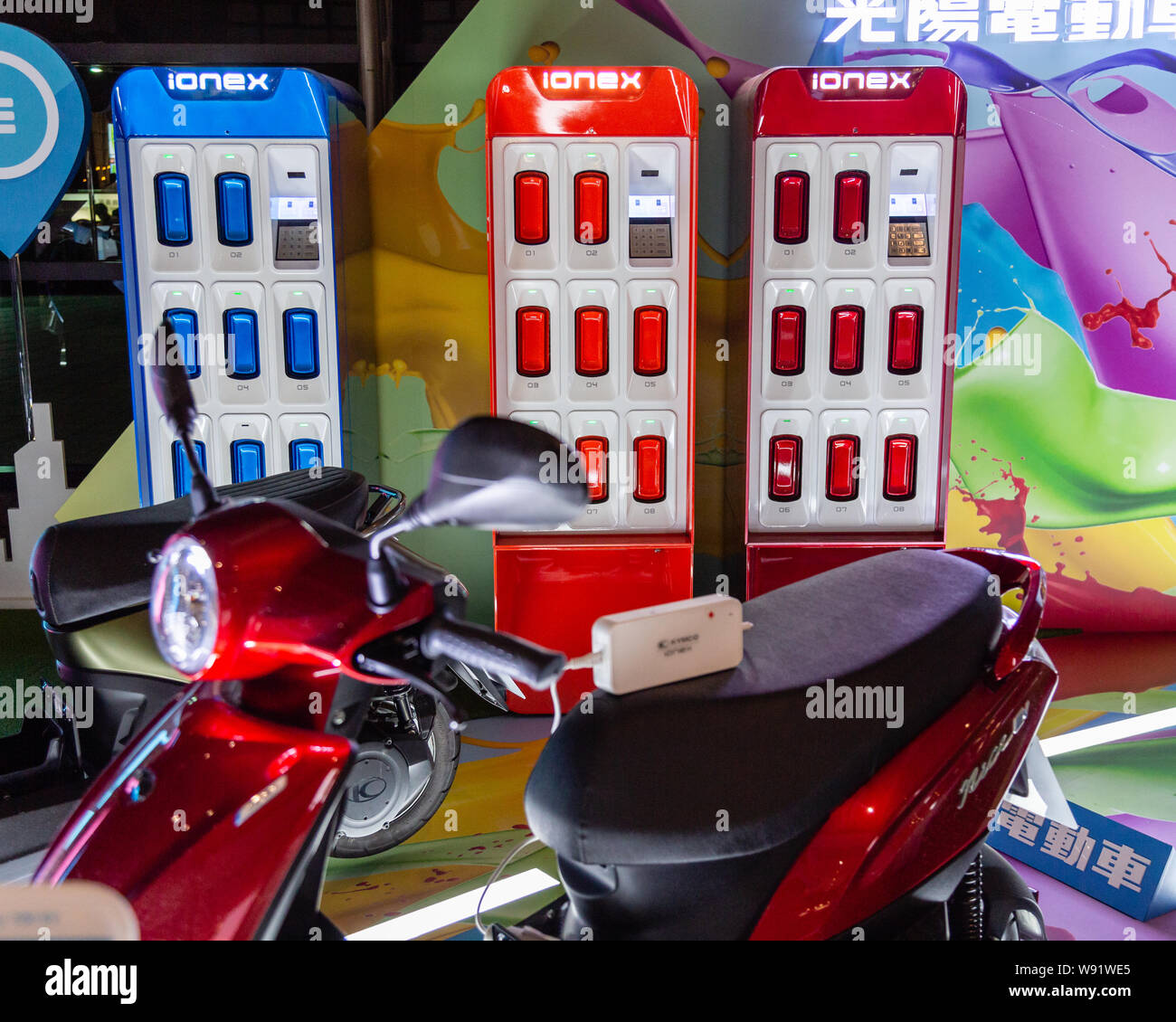 Taichung, Taiwan - August 4, 2019: Kymco IoneX battery-powered electric scooter display with batteries and charging stations. Alternative energy conce Stock Photo