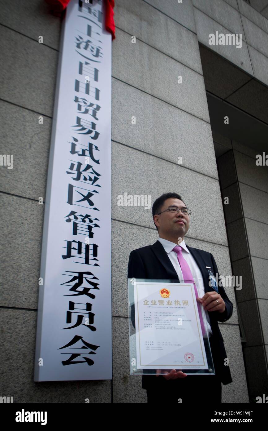 A representatives of an overseas enterprise poses with the new specialized business license for enterprises in China (Shanghai) Pilot Free Trade Zone Stock Photo