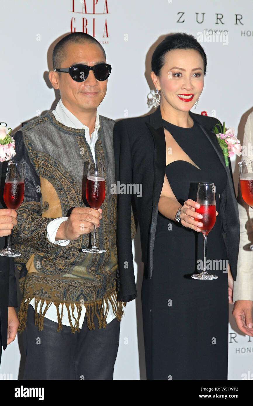 Hong Kong actor Tony Leung Chiu Wai, left, and his actress wife Carina Lau propose toasts during the opening ceremony for Carina Laus restaurants in H Stock Photo