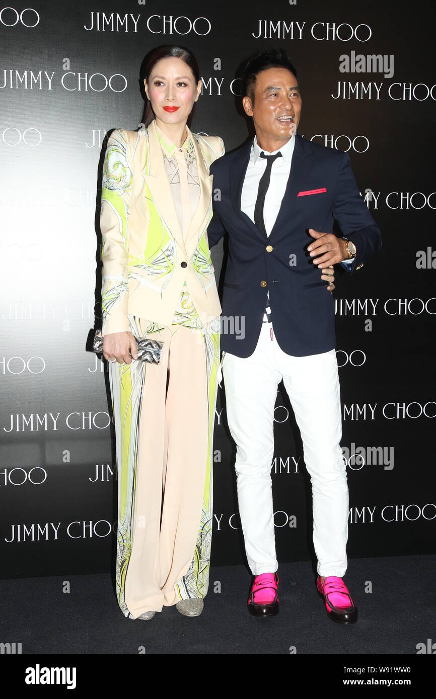 Hong Kong actor Simon Yam, right, and his model wife Qi qi pose as they arrive at the opening party of a new Jimmy Choo boutique in Hong Kong, China, Stock Photo
