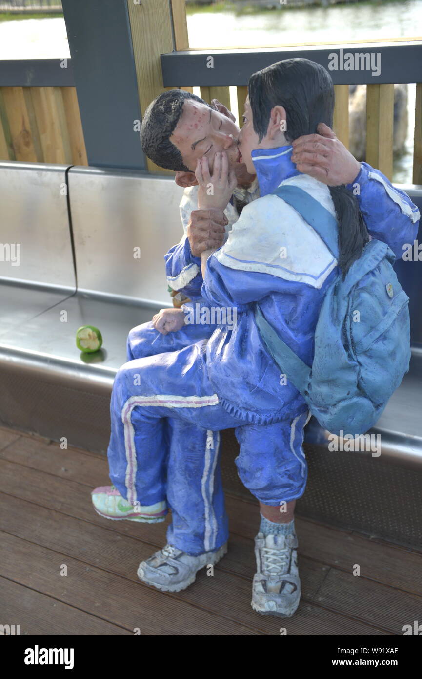 A statue showing two middle school students kissing each other is displayed at a park in Zhangzhou city, southeast Chinas Fujian province, 24 May 2013 Stock Photo