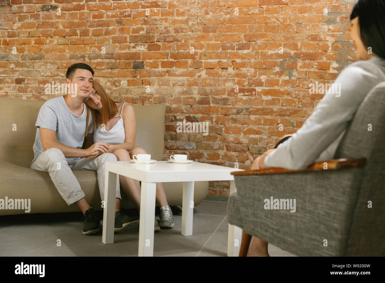 Couple in therapy or marriage counseling. Psychologist, counselor, therapist or relationship consultant giving advice. Man and woman sitting on a psychotherapy session. Family, mental health concept. Stock Photo