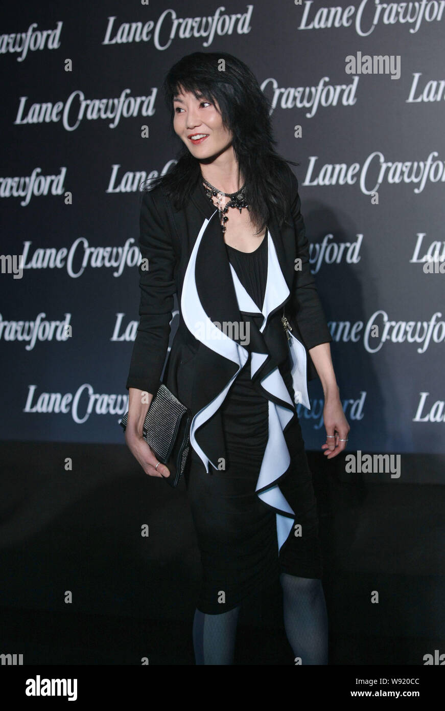 Hong Kong actress Maggie Cheung poses during the opening ceremony for the flagship store of LaneCrawford in Shanghai, China, 23 October 2013. Stock Photo